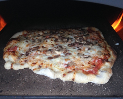 Delicious wood fired pizza cooked in the outdoor pizza oven to perfection